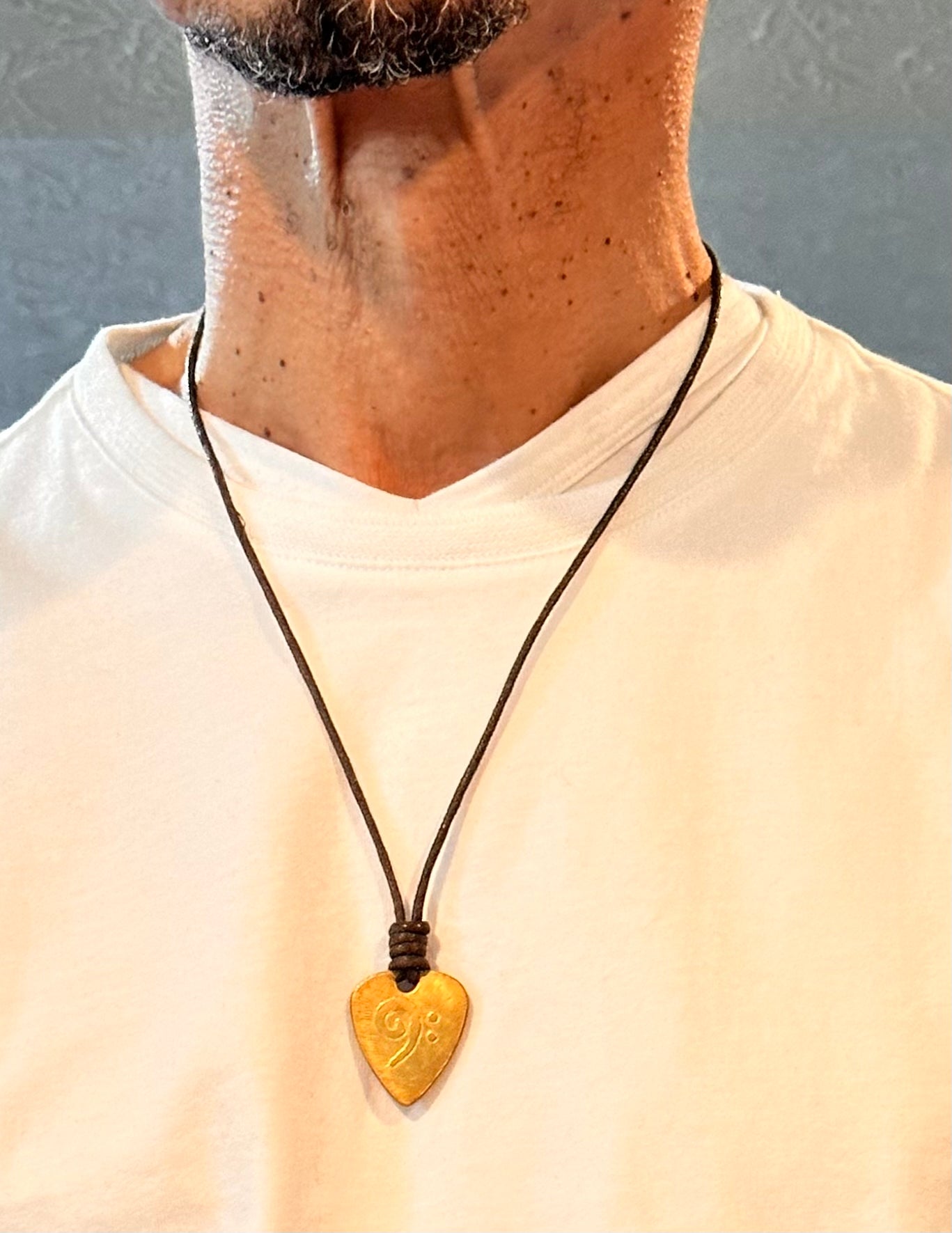 Brass Guitar Pick Pendant with an Etched Bass Clef Design