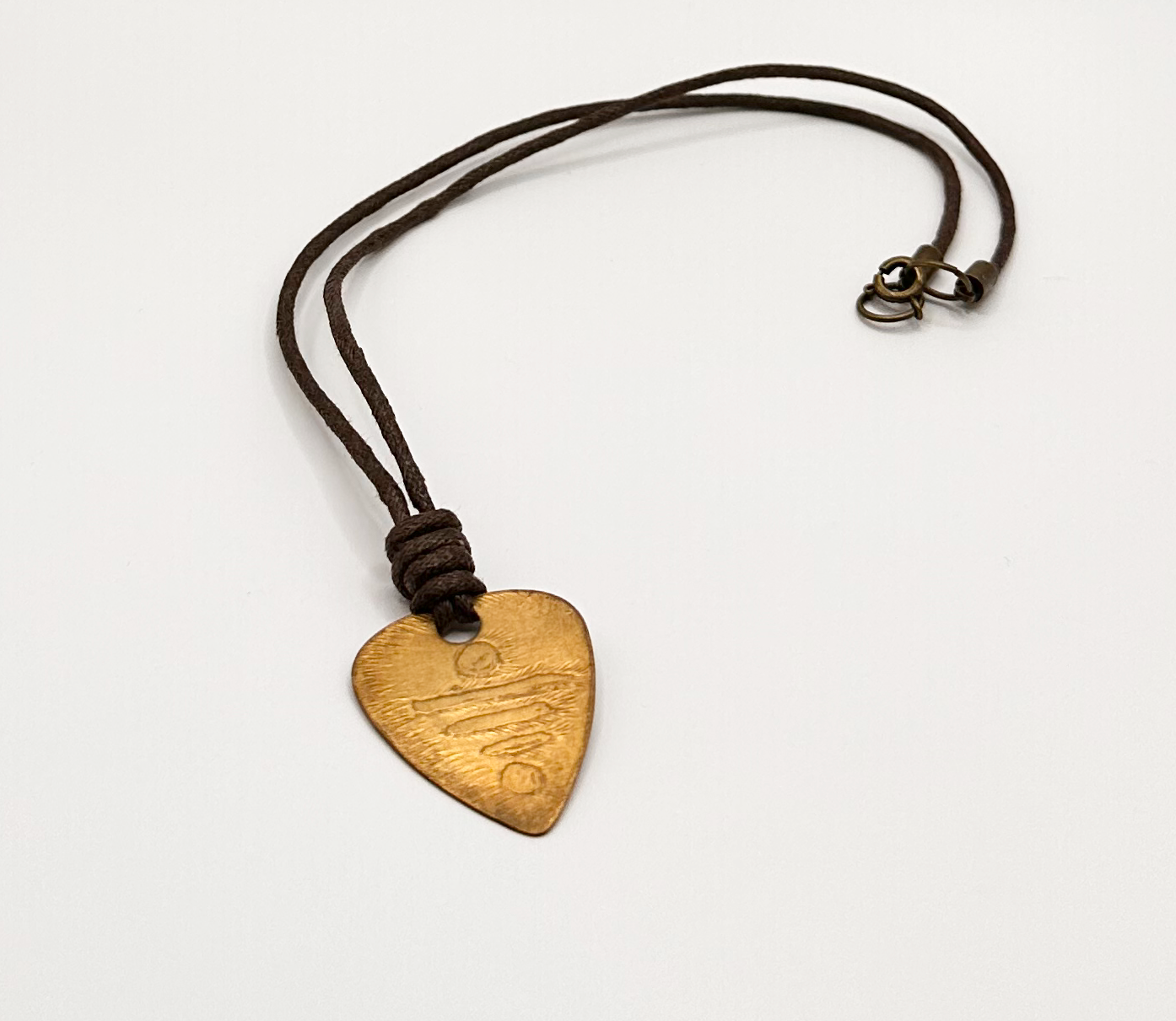 Brass Guitar Symbol Pick Pendant with an Etched Contemporary Design